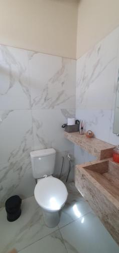 a white bathroom with a toilet and a counter at Studio Figueira, Sol in Santarém