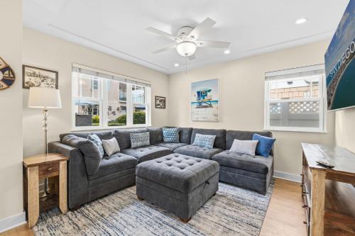 a living room with a couch and a table at Stunning beach home - steps2sand, AC, Large Patio and Fast Wifi! in San Diego