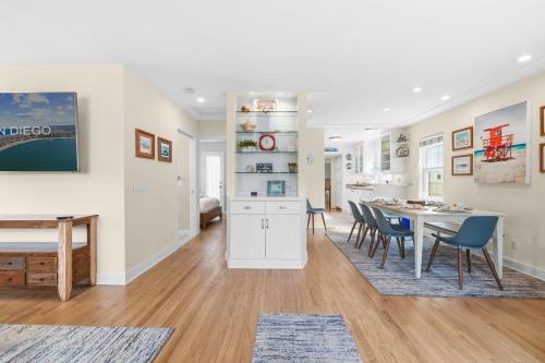 a kitchen and dining room with a table and chairs at Stunning beach home - steps2sand, AC, Large Patio and Fast Wifi! in San Diego