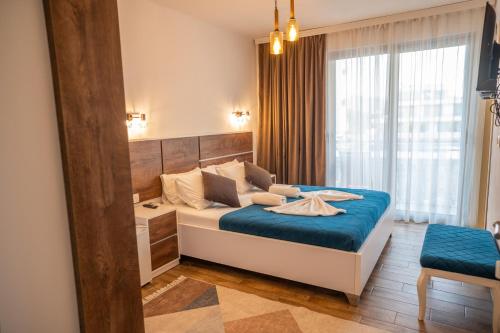 a bedroom with a large bed with a blue blanket at Vila Kollari in Ulcinj