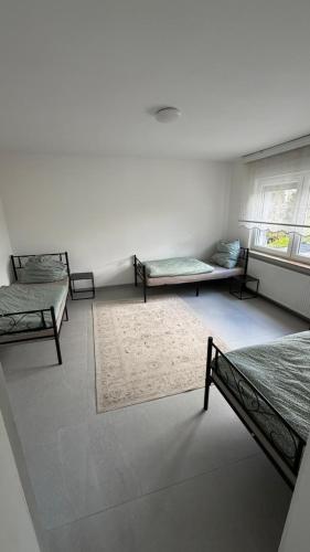 a room with two beds and two windows at WorkHome A2 zu 6 in Lünen