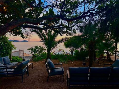 a patio with chairs and a view of the ocean at Old Stone House in Mlini