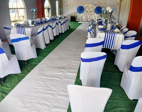 a row of tables and chairs in a banquet hall at Lefi Recreational Park in Wolmaranstad