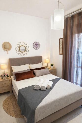 a bedroom with a bed with two towels on it at Diamond Rod Villa near Faliraki in Kalithies
