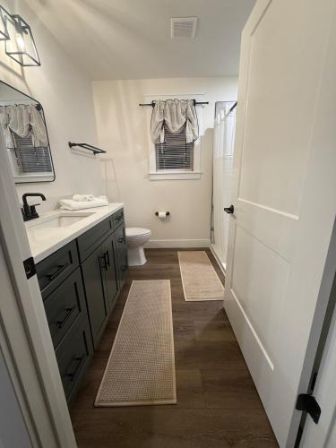a white bathroom with a sink and a toilet at Doc Hollywood in Stanton