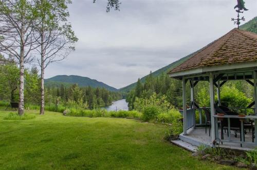 a gazebo with a view of a river at Secluded River View Hideaway in Hungry Horse