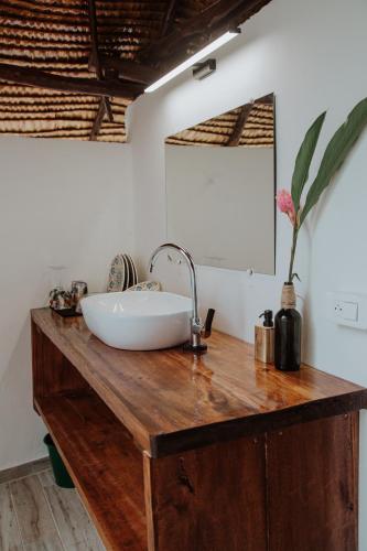 a bathroom with a sink on a wooden counter at Fare Hau Lodge in Tahaa