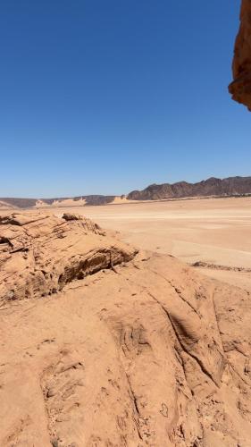 a view of the desert from a rock formation at وادي رم مخيم عادل in Wadi Rum