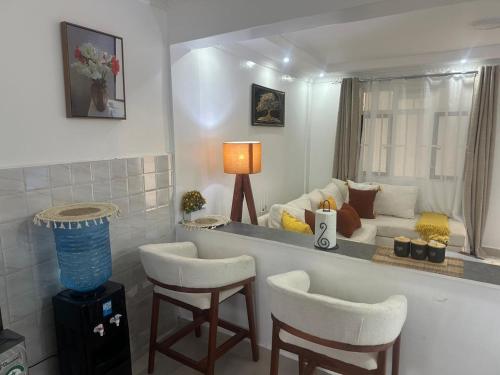 a living room with a couch and two chairs at Grace Homes in Naivasha