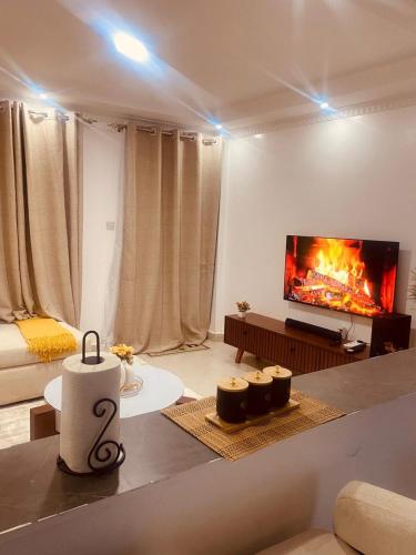 a living room with a fire in the fireplace at Grace Homes in Naivasha