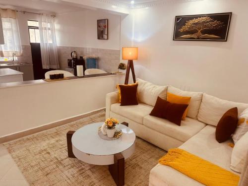 a living room with a couch and a table at Grace Homes in Naivasha