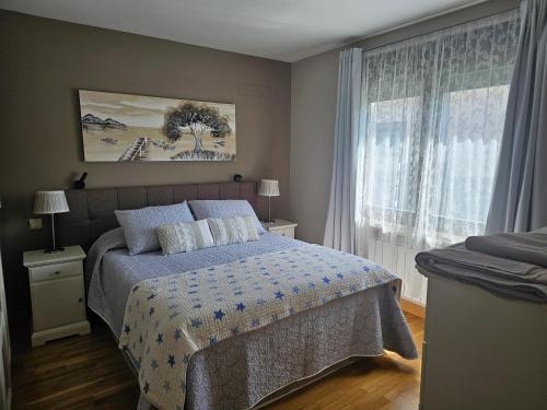 a bedroom with a bed and a large window at Casa Tejada in San Rafael