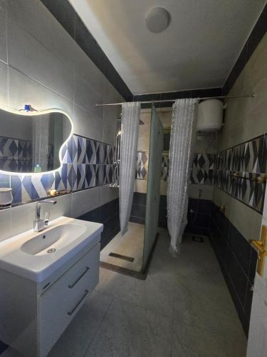 a bathroom with a sink and a shower at النزهه in Quseir