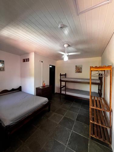 a bedroom with a bed and a ladder in it at Pousada N'ativaMar in Guaratuba