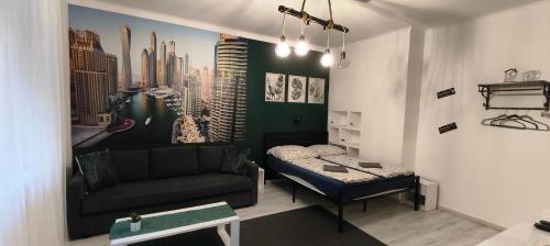 a living room with a couch and a bed at Mérey Apartment in Szeged
