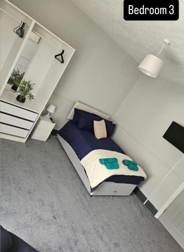 a bedroom with a bed in the corner of a room at The Queens Hotel in Rhondda