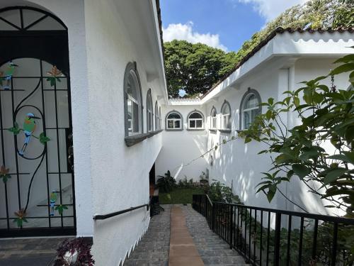 a white house with a gate and a walkway at Quinta Pompella in San Salvador