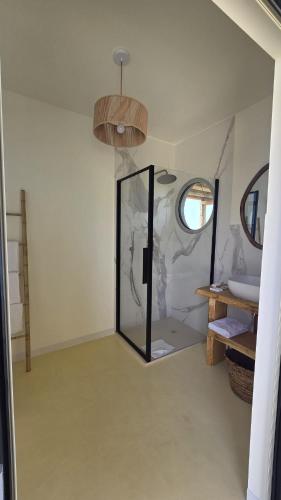 a bathroom with a mirror in a room at Tendu' Punta Bianca Glamping Camp in Palma di Montechiaro