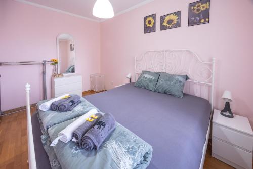a bedroom with a large bed and a mirror at Apartment Sunflower021 in Novi Sad