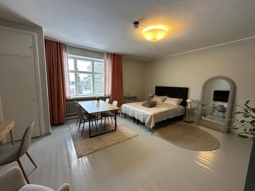 a bedroom with a bed and a table and a desk at Villa Karijoki in Karijoki