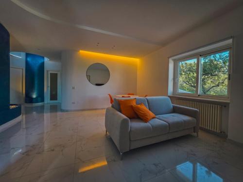 a living room with a couch and a large window at Casa Zora - Vista Mare in Vieste