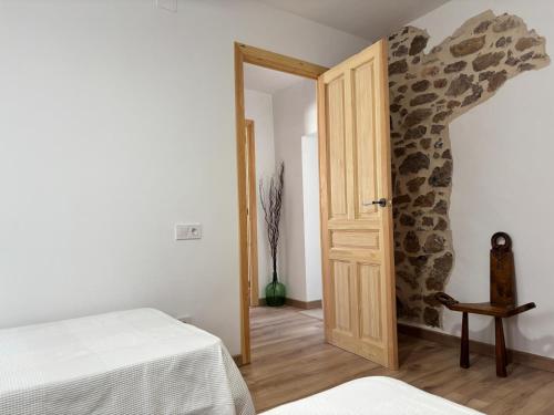 a room with a room with two beds and a door at Les Coves de Lluna in Vall de Uxó
