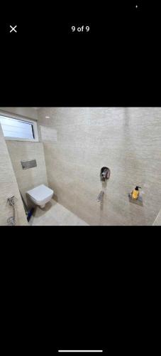 a bathroom with a toilet and a sink at Pink villa inn in Guwahati