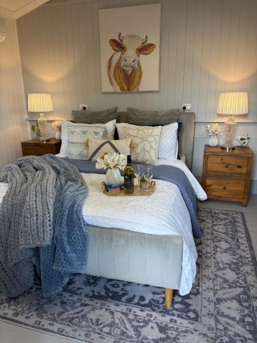 a bedroom with a bed with a table on it at Edington on Mary - The Dairy in Gympie