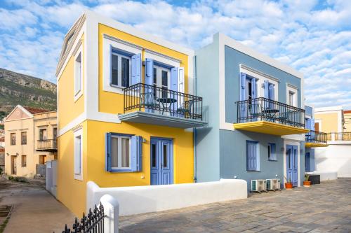 a colorful house with blue windows and balconies at Twelve 12 Islands in Symi
