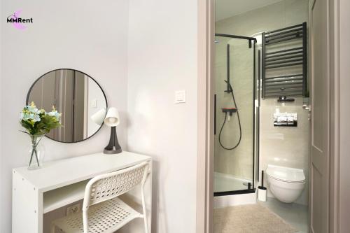 a bathroom with a mirror and a sink and a toilet at MMRent Grape Room in Gdańsk