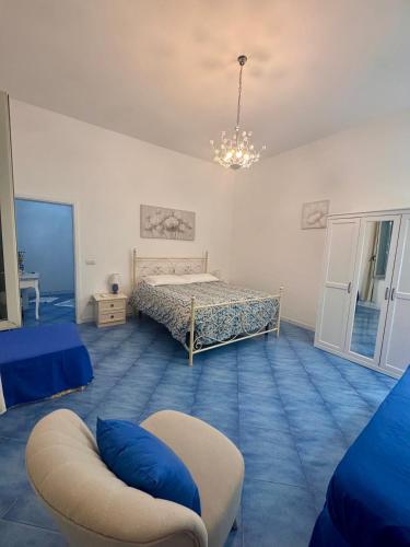 a bedroom with a bed and a chair in it at IL PROFUMO DEI FIORI SUITE in Praiano