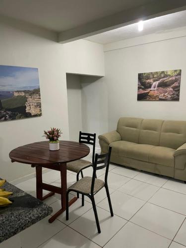 a living room with a table and a couch at Casa em Seabra in Seabra