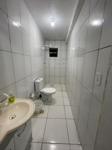 a white bathroom with a toilet and a sink at Casa em Seabra in Seabra