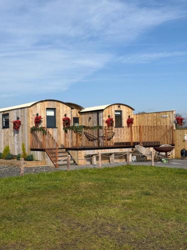 a row of cottages with flower boxes on them at The Shepherds Chalet in Garstang