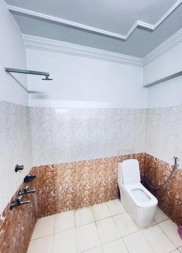 a bathroom with a toilet in a room at Shree Sanwariya Hotel in Chittaurgarh