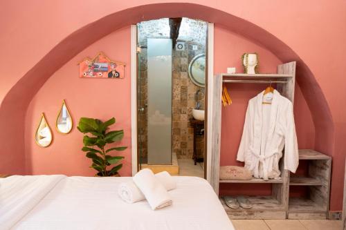 a bedroom with a white bed and a mirror at Attiki Hotel in Rhodes Town