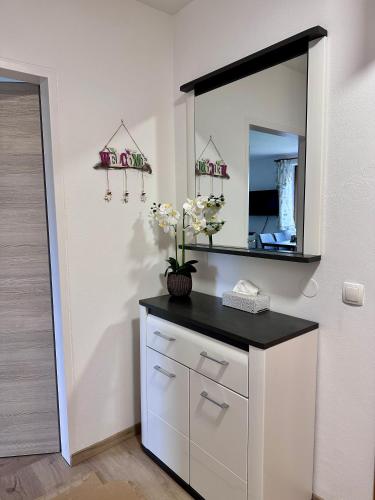 a bathroom with a vanity with a mirror on the wall at Ferienwohnung Petritz in Velden am Wörthersee