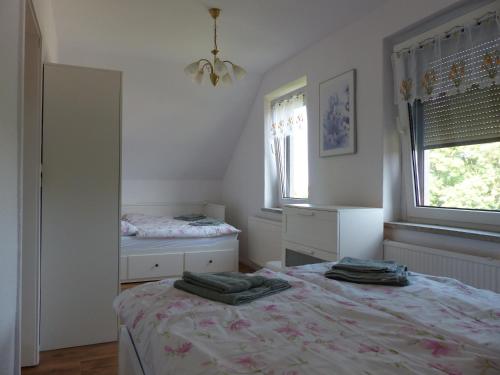 a bedroom with two beds and a mirror at Ferienwohnung in Ostseenähe 1 in Velgast