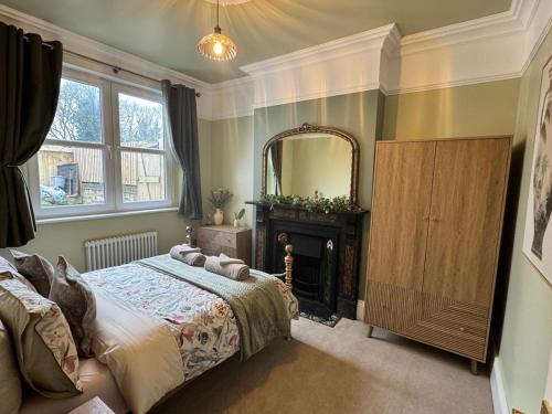 a bedroom with a bed and a mirror at Moody House in Congleton