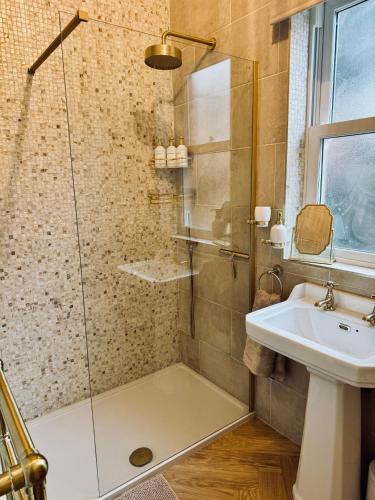 a bathroom with a shower and a sink at Moody House in Congleton