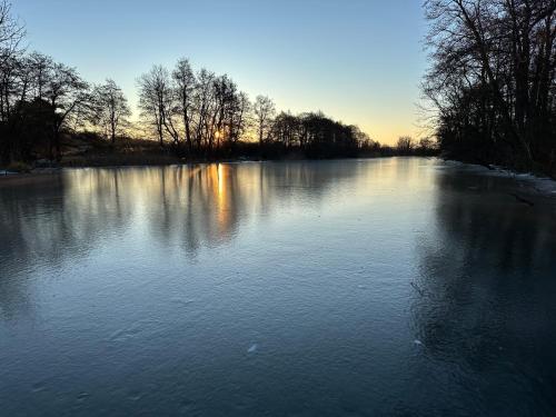 a large lake with snow on the water at Ferienwohnung am Warnowhang in Kessin