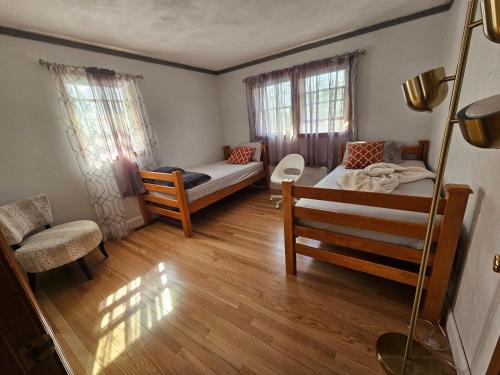a small room with a bed and a couch at Dracut Executive Rooms with Kitchen & Bath, Parking, Spacious & Comfortable in Dracut