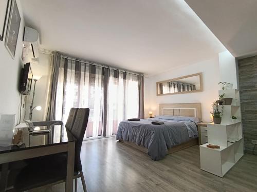 a white bedroom with a bed and a desk and a desk at GARRUCHA HOME AND BEACH in Garrucha
