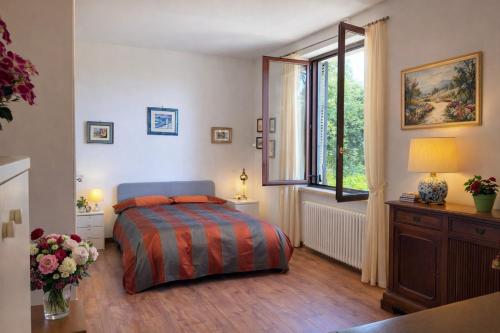 a bedroom with a bed and a window at Casa Yoga 2 Rilassati in una oasi di pace immersa nella natura a soli 60 minuti da Roma in Bassano Romano