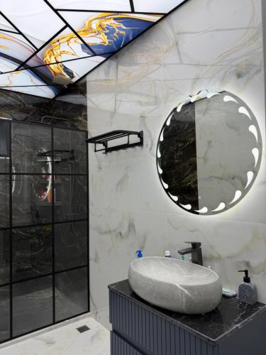 a bathroom with a round sink and a mirror at Novxanı Villa in Baku
