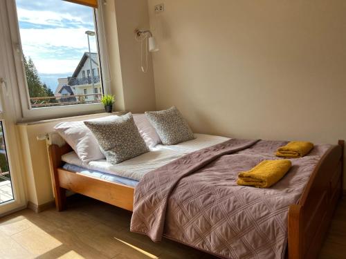 a bed in a room with a large window at SAViTA in Karwia
