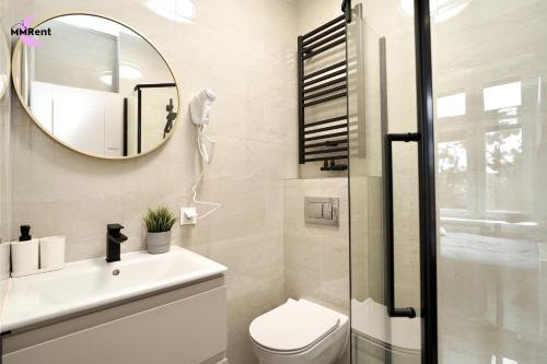 a bathroom with a toilet and a mirror at MMRent Colorful Room in Gdańsk