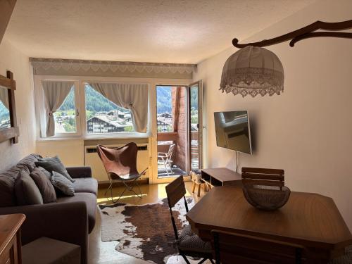 a living room with a couch and a table at Casa Raggio di Sole in La Thuile