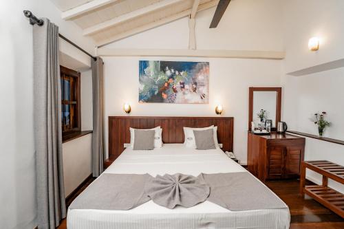 a bedroom with a bed with a bow on it at Arches Fort in Galle