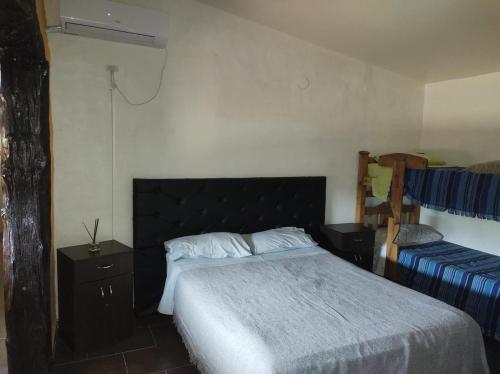a bedroom with a large bed and a nightstand and a bed sidx sidx sidx at Finca el gallego in Junín